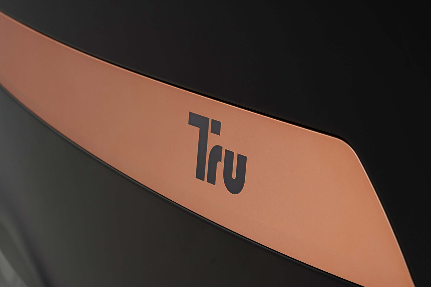 Close-up of the Tru logo on the sleek design of the Tru Symphony Plus 4D Massage Chair.
