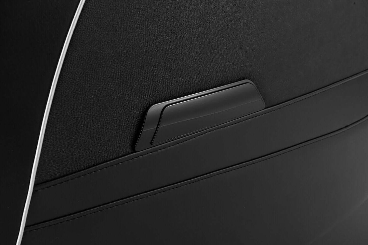 Close-up of the TRU Majestic massage chair's sleek black fabric and storage pocket design.